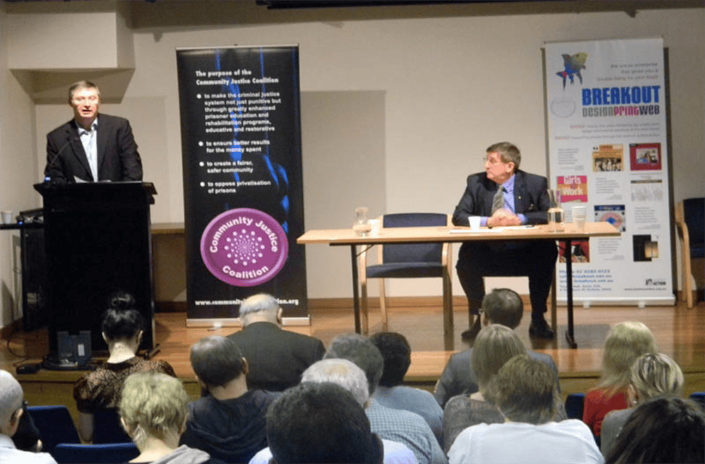 Community Justice Coalition speaker at Post Election Forum 2012 discussing justice issues.